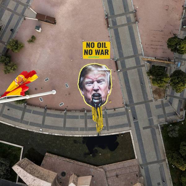 Greenpeace Spain activists displayed a giant image of US President Donald Trump vomiting oil