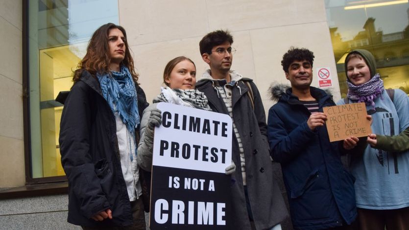 Greta Thunberg stands with other climate activists