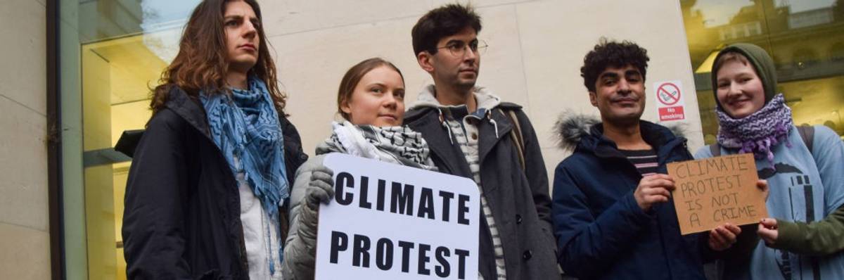 Greta Thunberg stands with other climate activists