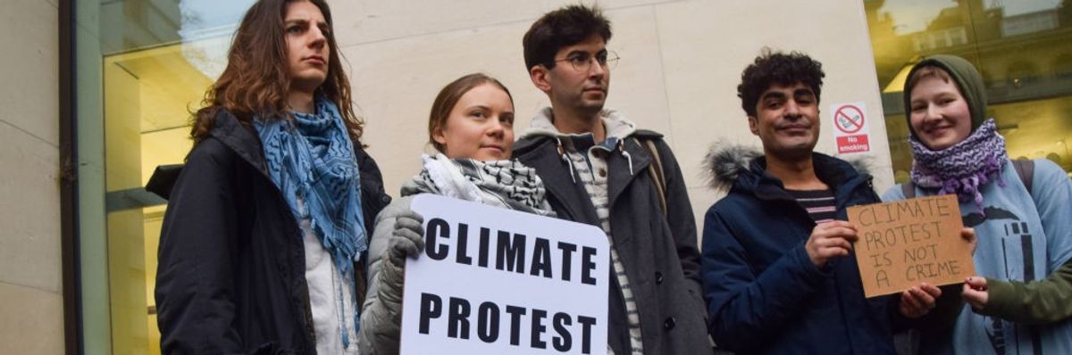 Greta Thunberg stands with other climate activists