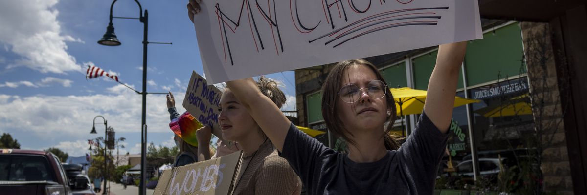 group of teenagers protests the Supreme Court's decision