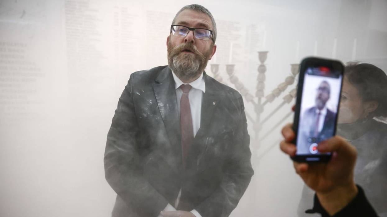 Grzegorz Braun after using fire extinguisher on menorah