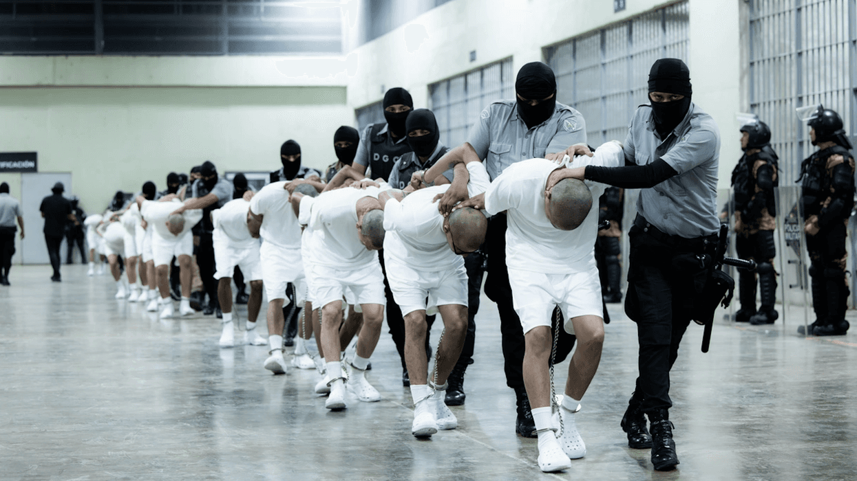 Guards handle prisoners at CECOT