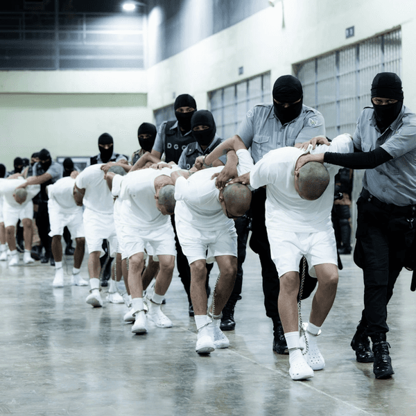 Guards handle prisoners at CECOT