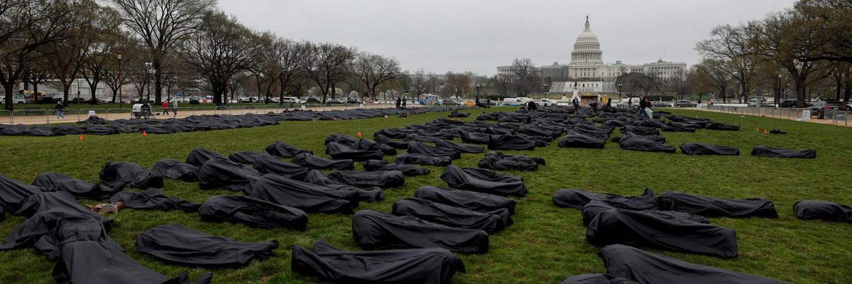 Gun control advocates spell "Thoughts and Prayers" with body bags on Capitol Hill