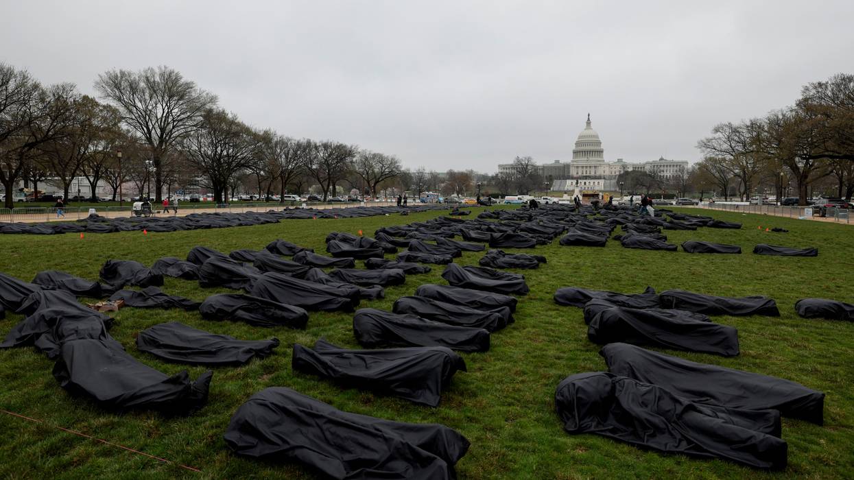Gun control advocates spell "Thoughts and Prayers" with body bags on Capitol Hill