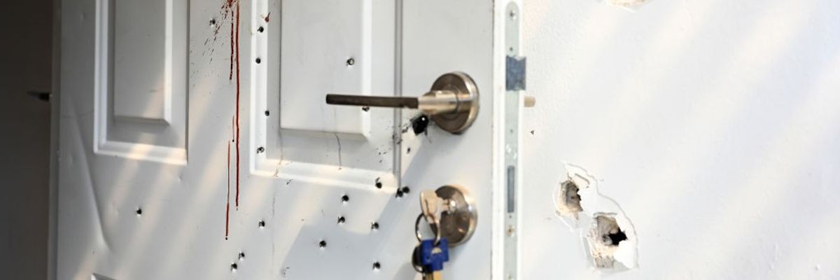 Gunshots and blood stains are seen on a door and walls in Israel