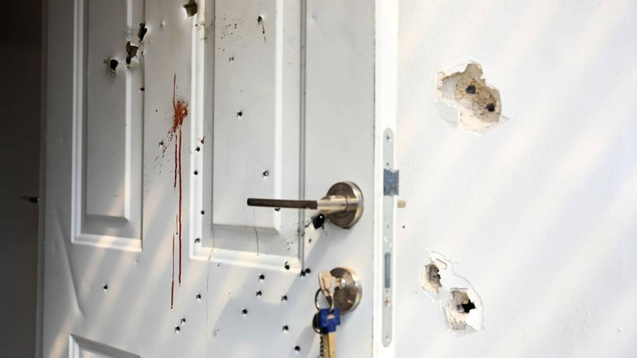 Gunshots and blood stains are seen on a door and walls in Israel