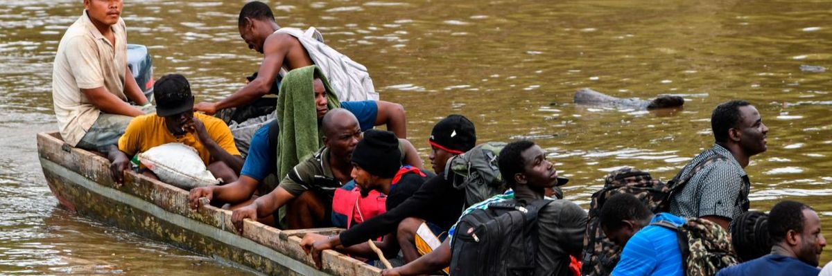 Haitain migrants cross a river into Panama on their way to the US