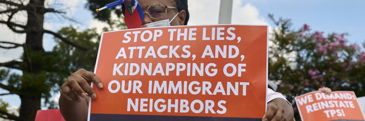 Haitian immigrants protester with sign