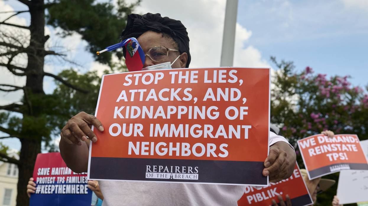 Haitian immigrants protester with sign