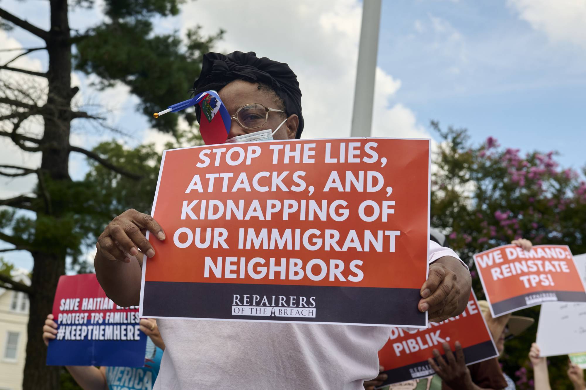 Haitian immigrants protester with sign