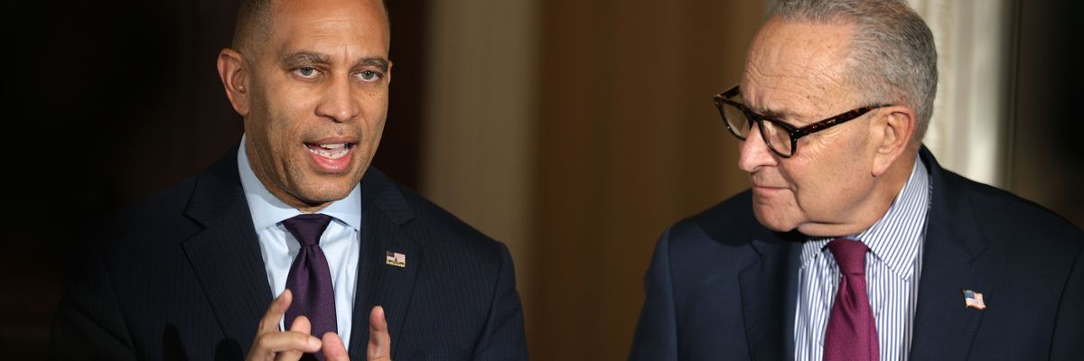 Hakeem Jeffries speaks while Chuck Schumer looks on