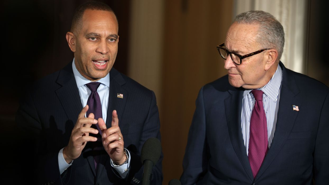 Hakeem Jeffries speaks while Chuck Schumer looks on