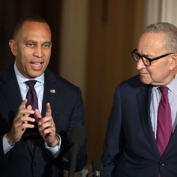 Hakeem Jeffries speaks while Chuck Schumer looks on