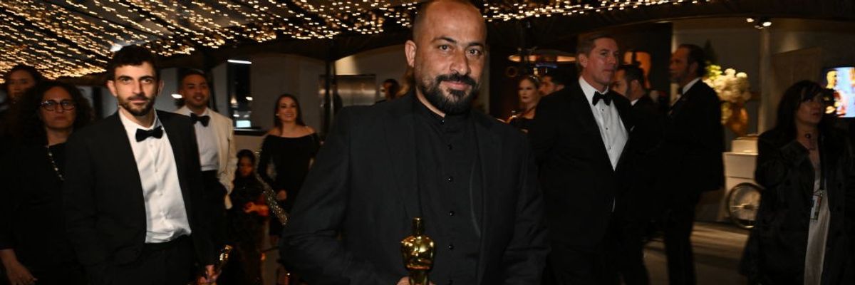 Hamdan Ballal holds his Oscar at the Academy Awards