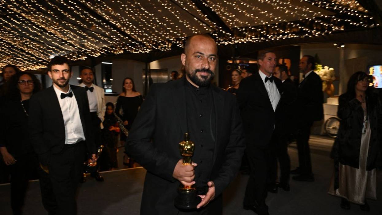 Hamdan Ballal holds his Oscar at the Academy Awards