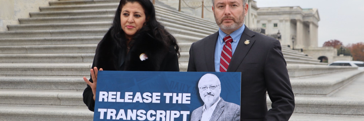 Hanan Elatr Khashoggi and Rep. Eugene Vindman stand outside the Capitol with a sign reading, "RELEASE THE TRANSCRIPT"