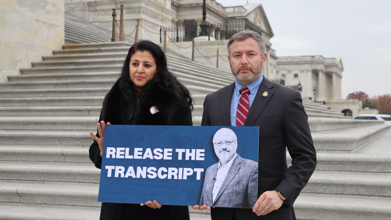 Hanan Elatr Khashoggi and Rep. Eugene Vindman stand outside the Capitol with a sign reading, "RELEASE THE TRANSCRIPT"