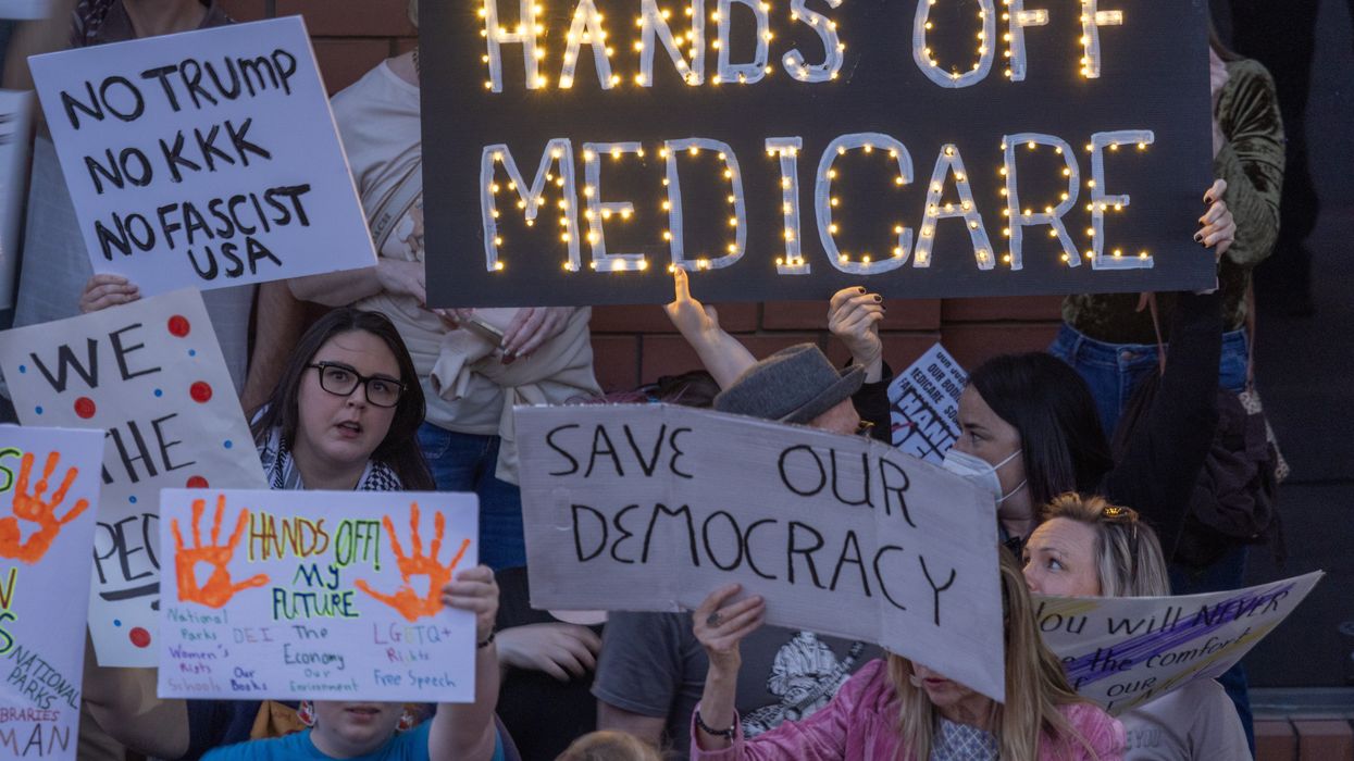 "Hands Off Medicare" sign held up at anti-Trump protest.