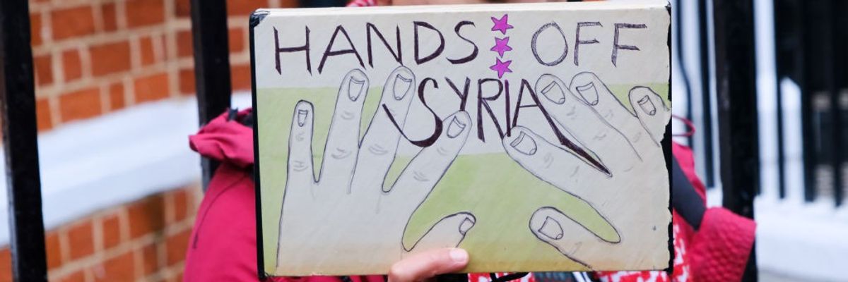 "Hands Off Syria," sign says