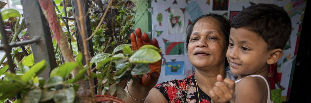 Hazera Begum takes care of children inside her shelter center in Dhaka, Bangladesh on May 8, 2022.