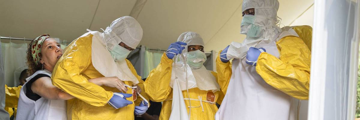 Health workers don protective gear amid an Ebola outbreak