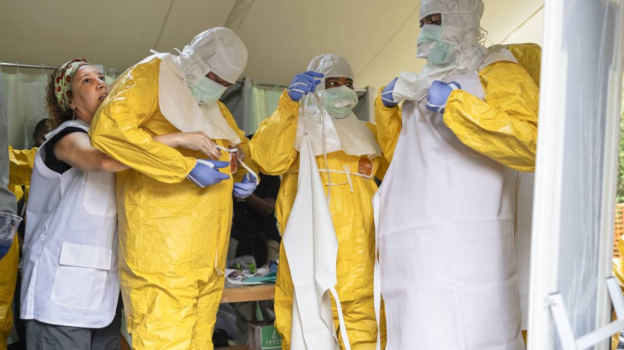 Health workers don protective gear amid an Ebola outbreak