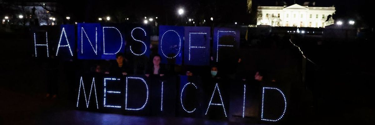 Healthcare advocates display "hands off Medicaid" message