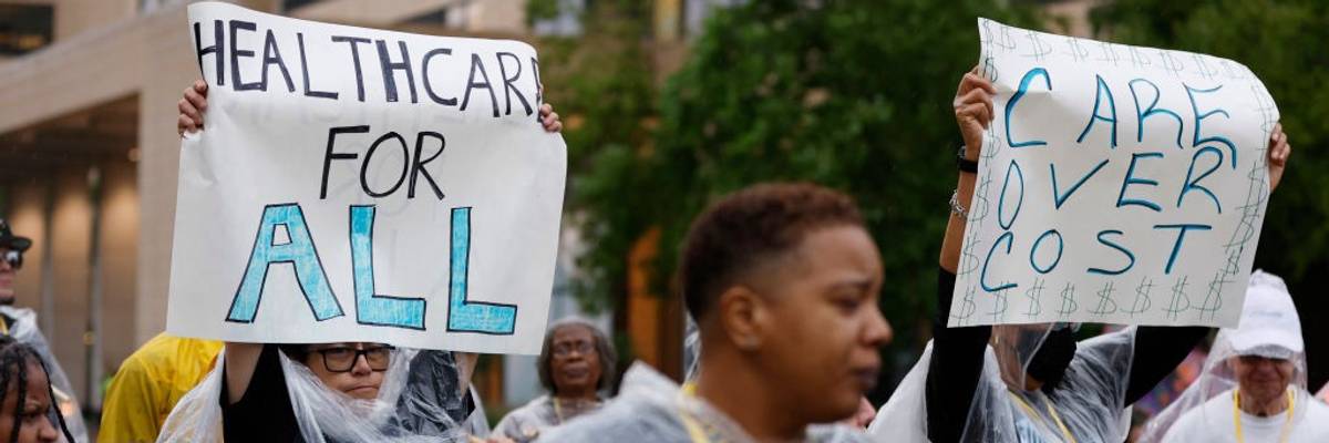 healthcare protest with sign reading "healthcare for all"