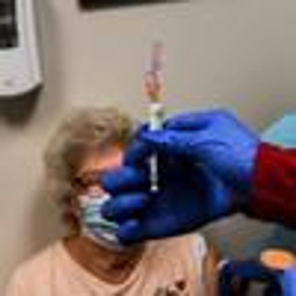 Healthcare worker Daisie Esseie receives a Pfizer-BioNtech Covid-19 vaccine from nurse practitioner Hari Leon Joseph at the Research Centers of America in Hollywood, Florida on December 18, 2020.