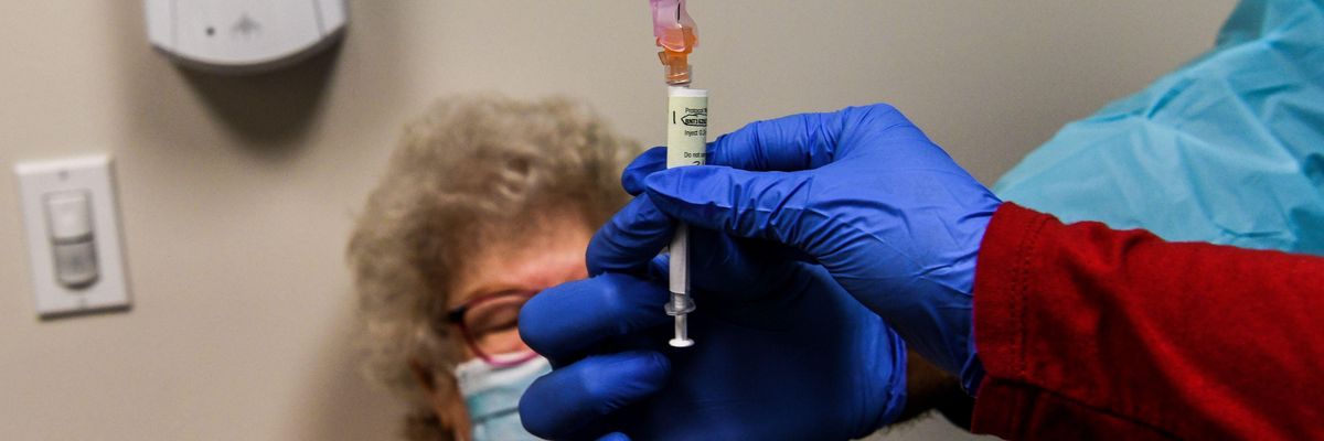 Healthcare worker Daisie Esseie receives a Pfizer-BioNtech Covid-19 vaccine from nurse practitioner Hari Leon Joseph at the Research Centers of America in Hollywood, Florida on December 18, 2020.