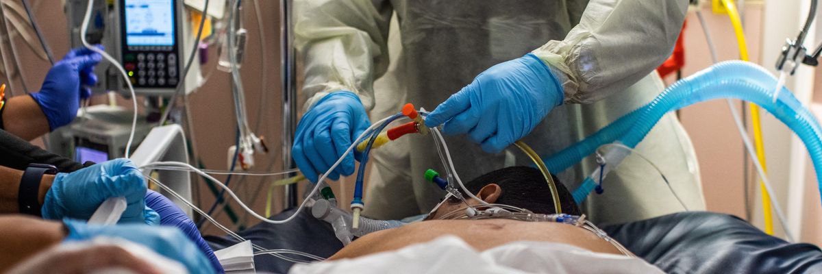 Healthcare workers attend to an unvaccinated 45-year-old Covid-19 patient