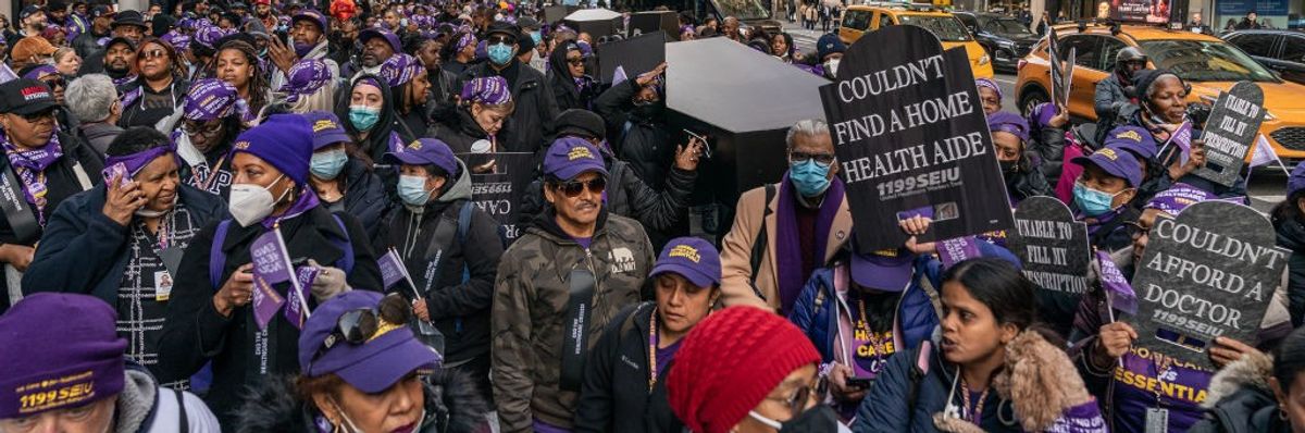 Healthcare workers carry fake coffin during New York protest. 