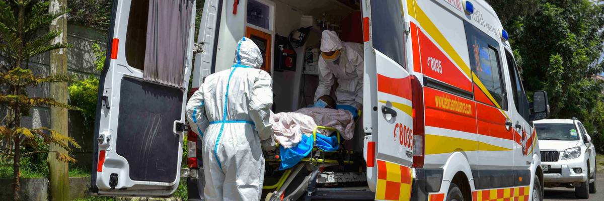 Healthcare workers evacuate a patient from his residence into an ambulance owned by a private company in Addis Ababa, Ethiopia