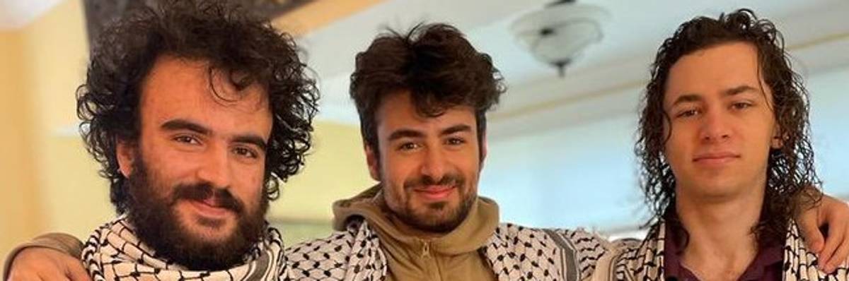 Hisham Awartani, Kinnan Abdel Hamid, and Tahseen Ahmed pose wearing keffiyehs.