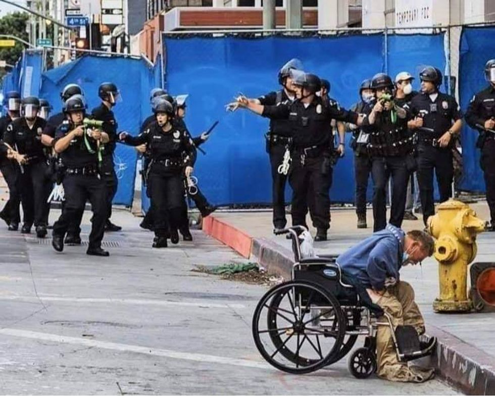 Homeless man Charf Lloyd being attacked by LAPD, in a photo taken and posted to Facebook by Kirk Tsonos