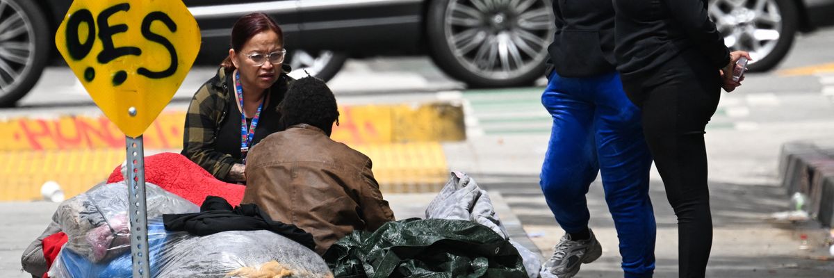Homeless person and outreach representative speak on street of LA.