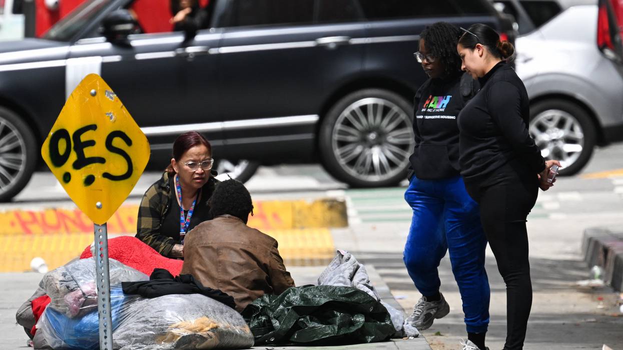 Homeless person and outreach representative speak on street of LA.