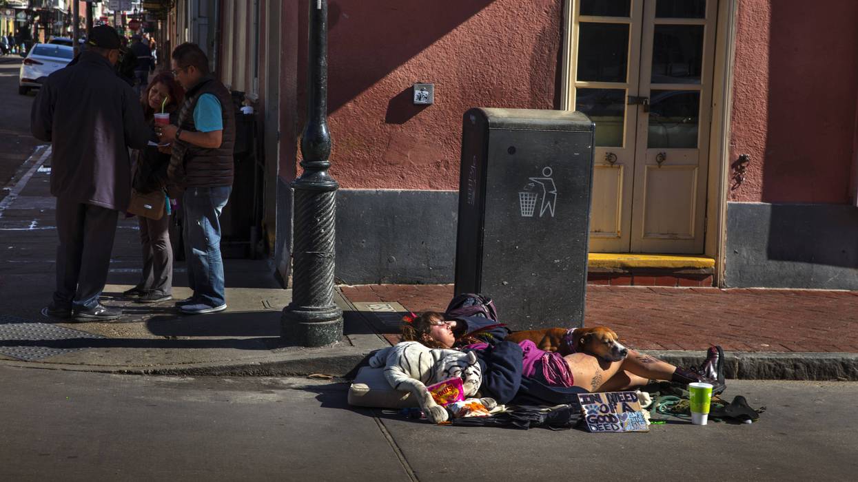 Homeless Woman Sleeping With Dog On Street