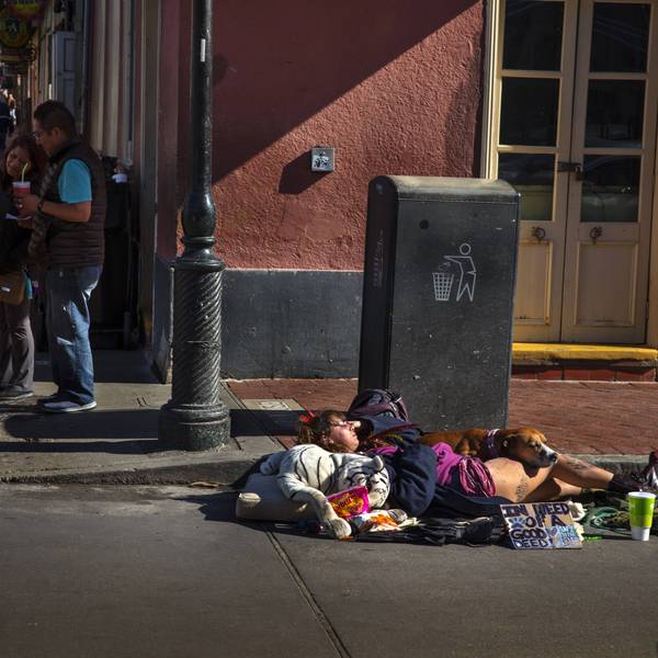 Homeless Woman Sleeping With Dog On Street