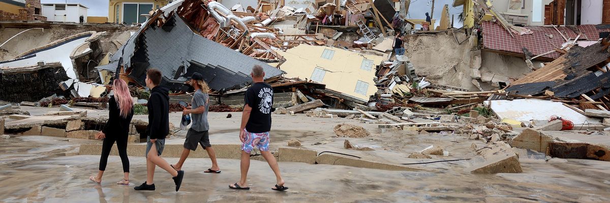 Homes are partially toppled onto the beach after Hurricane Nicole came ashore on November 10, 2022