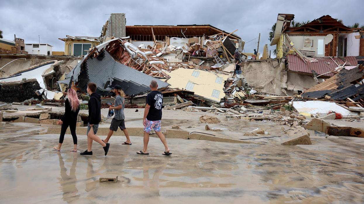 Homes are partially toppled onto the beach after Hurricane Nicole came ashore on November 10, 2022