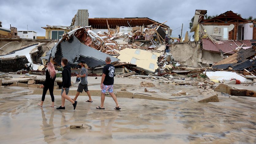 Homes are partially toppled onto the beach after Hurricane Nicole came ashore on November 10, 2022