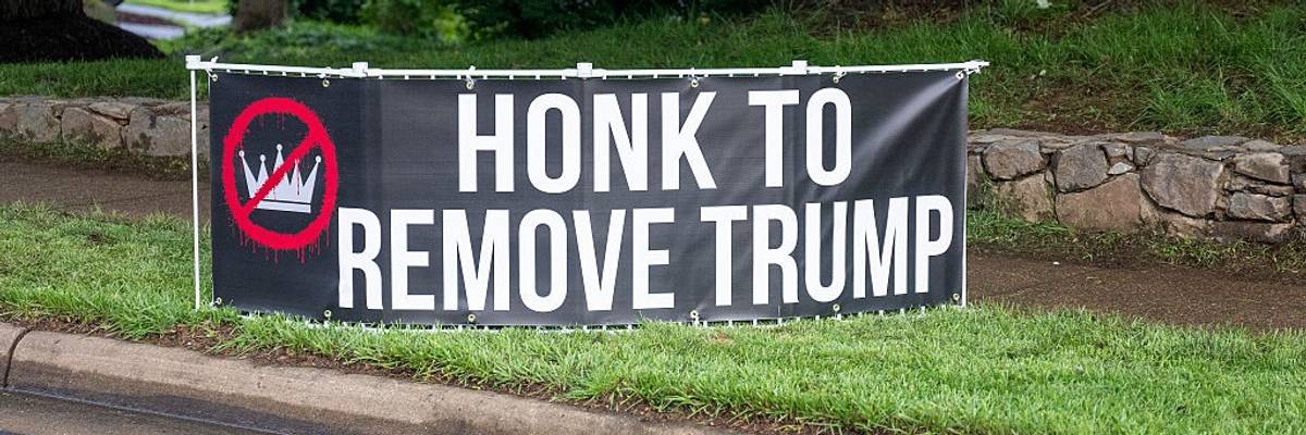 "Honk to Remove Trump," sign says.