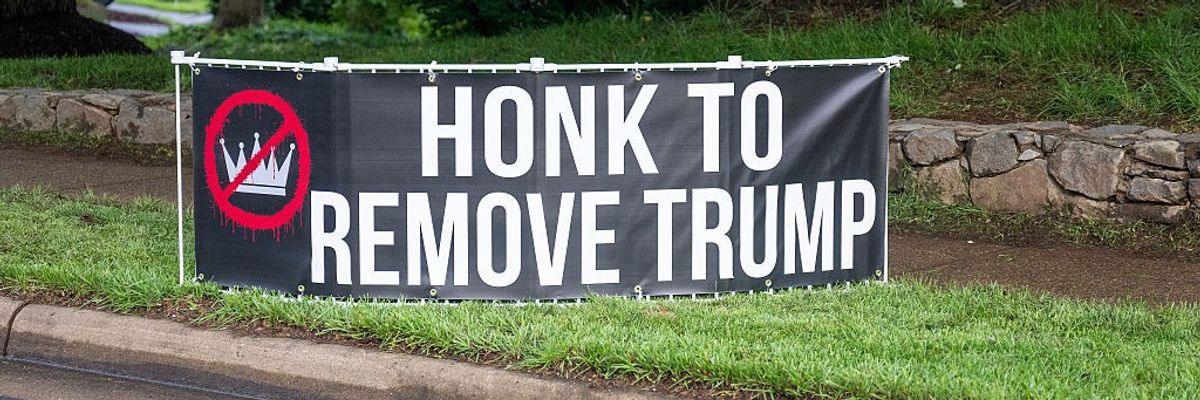 "Honk to Remove Trump," sign says.