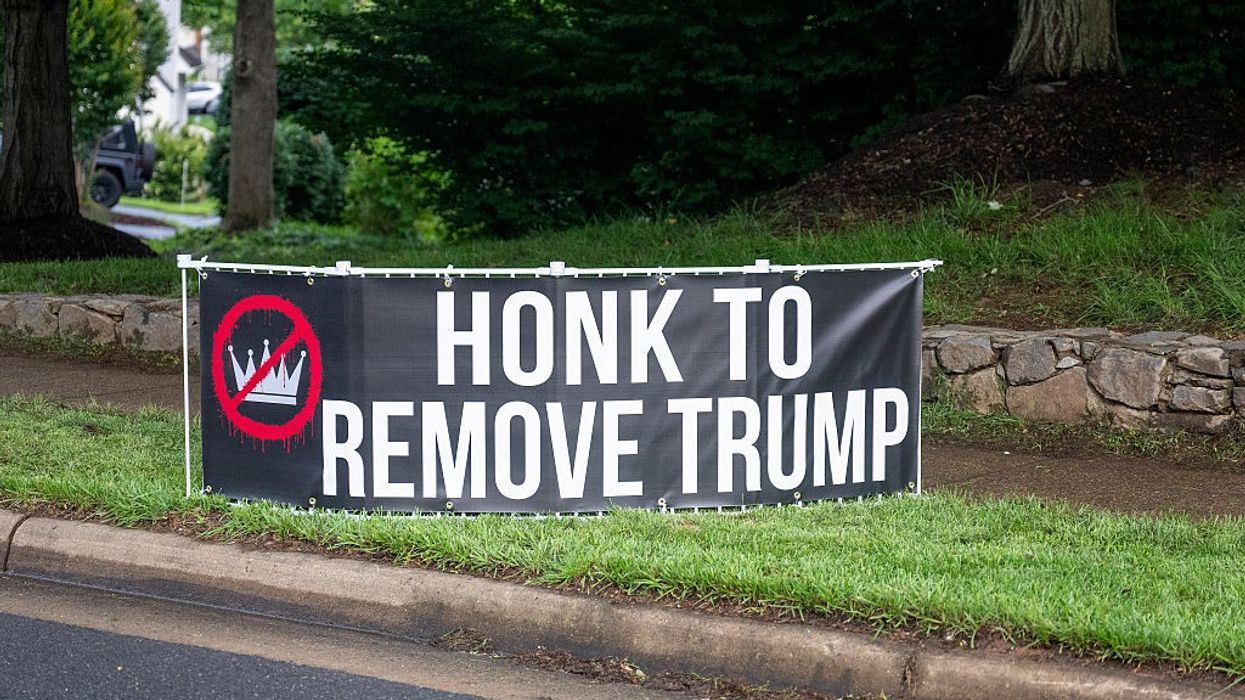 "Honk to Remove Trump," sign says.