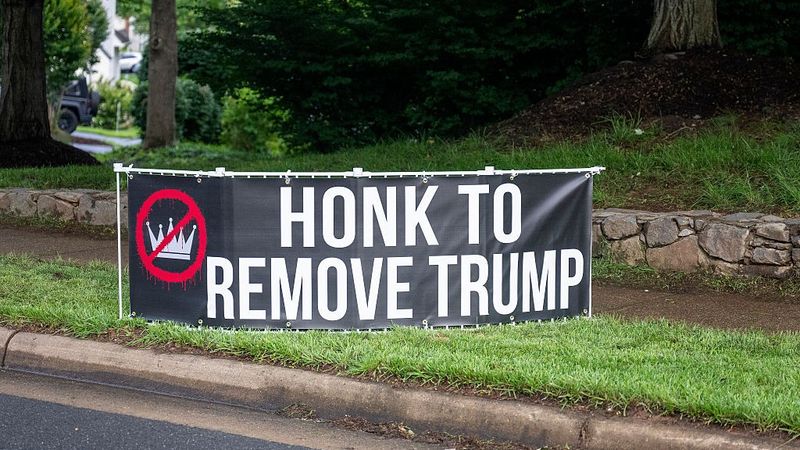 "Honk to Remove Trump," sign says.