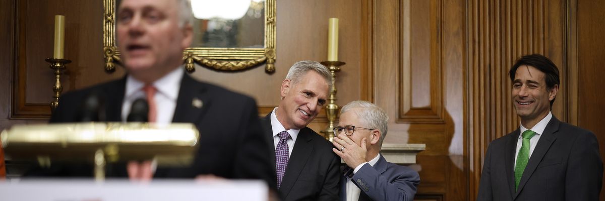 House Speaker Kevin McCarthy listens to Rep. Patrick McHenry during a news conference