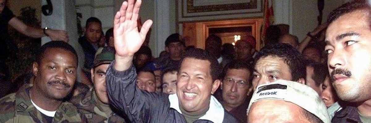 Hugo Chavez being returned to power on April13, 2002 after a right-wing coup briefly overthrew him.